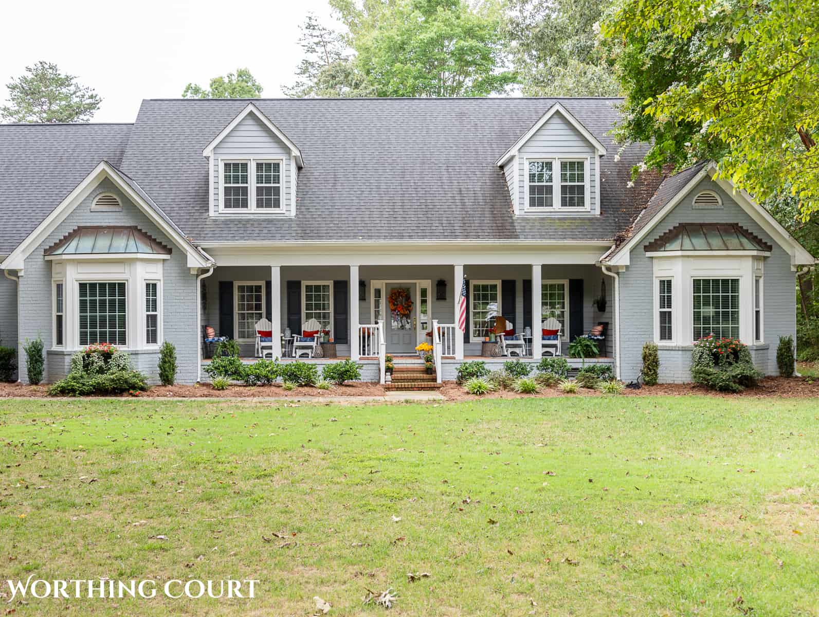 exterior of a gray house with a large front porch