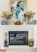 white brick fireplace with blue and white accessories and fall decorations