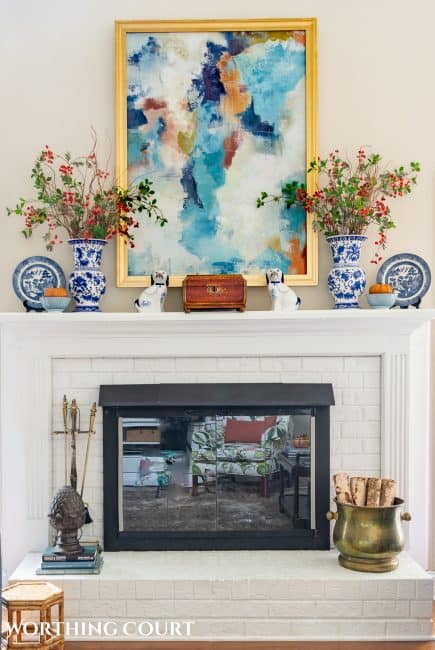 white brick fireplace with blue and white accessories and fall decorations
