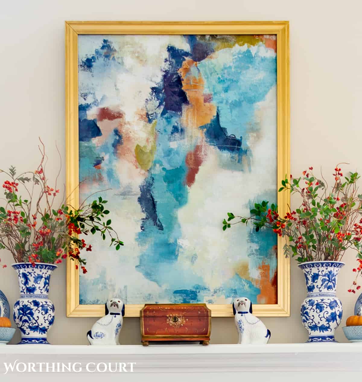 abstract art and blue and white accessories on a mantel