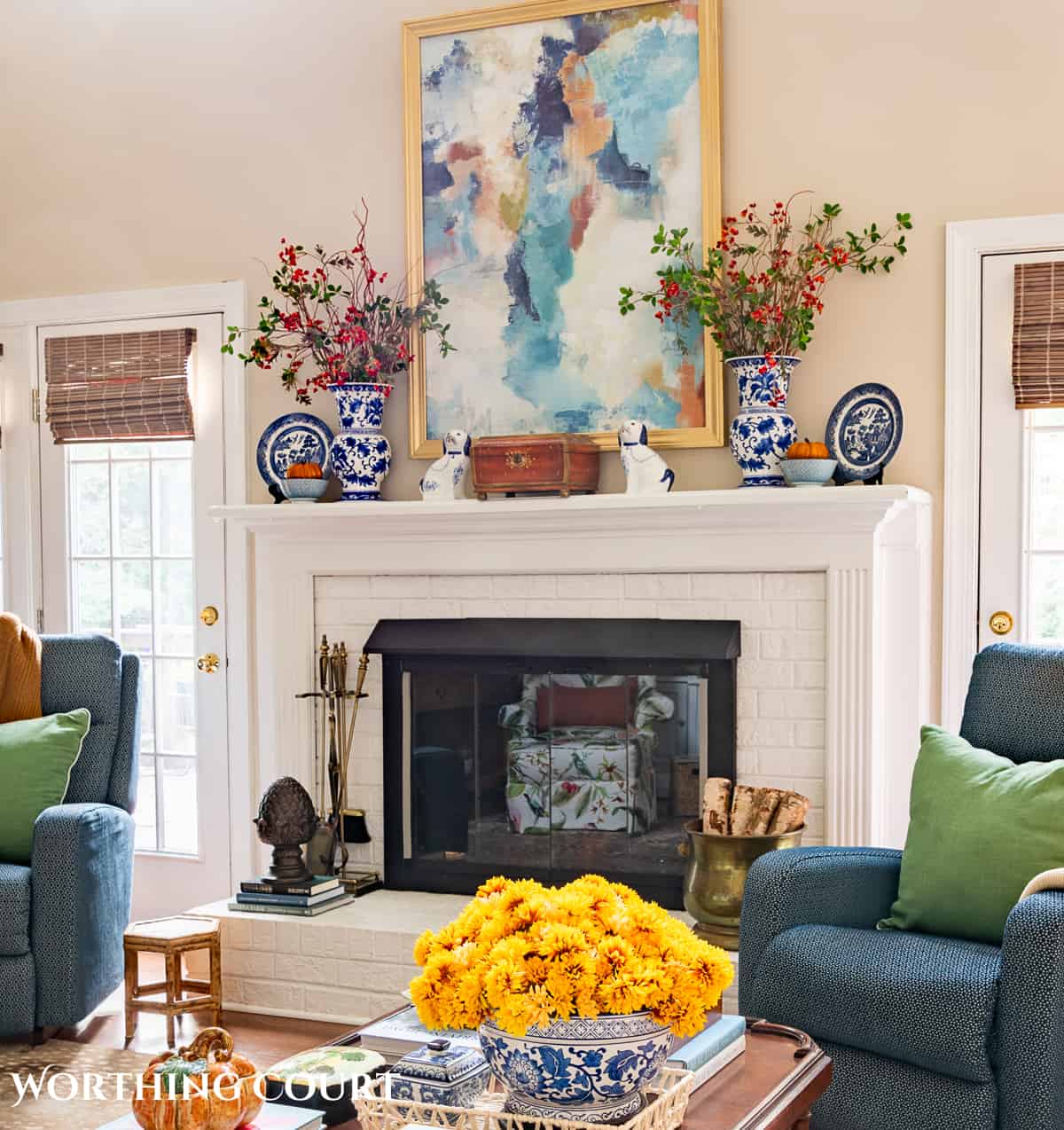 fall decorations on a white brink fireplace and mantel