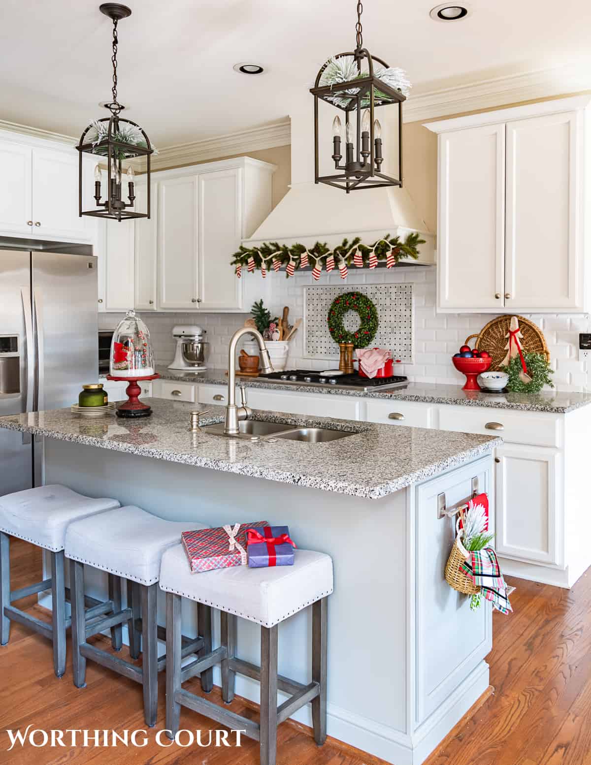 Christmas decorations in kitchen with white cabinets and a gray island