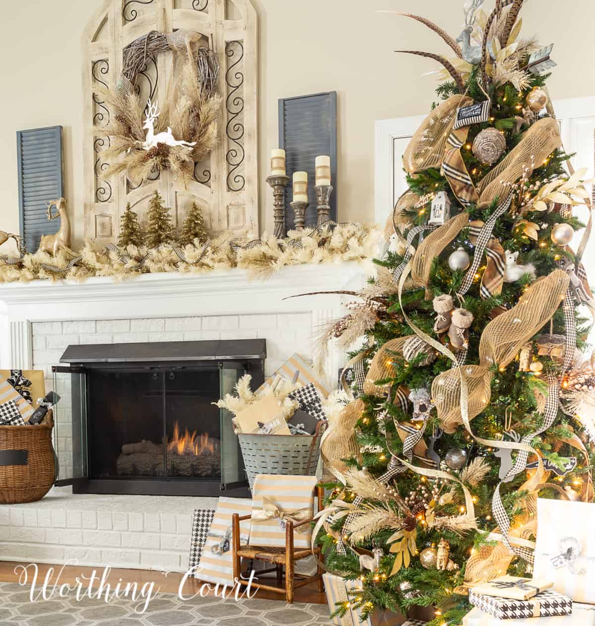 Christmas tree and fireplace decorated with gold and silver decor