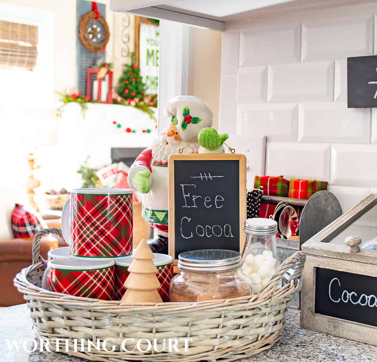 round wicker tray with a Santa holding a hot cocoa sign and Christmas mugs