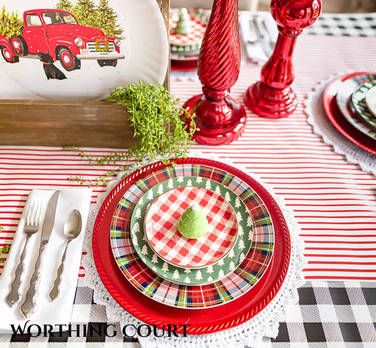 Christmas place setting with red, white, green and tartan plaid dishes
