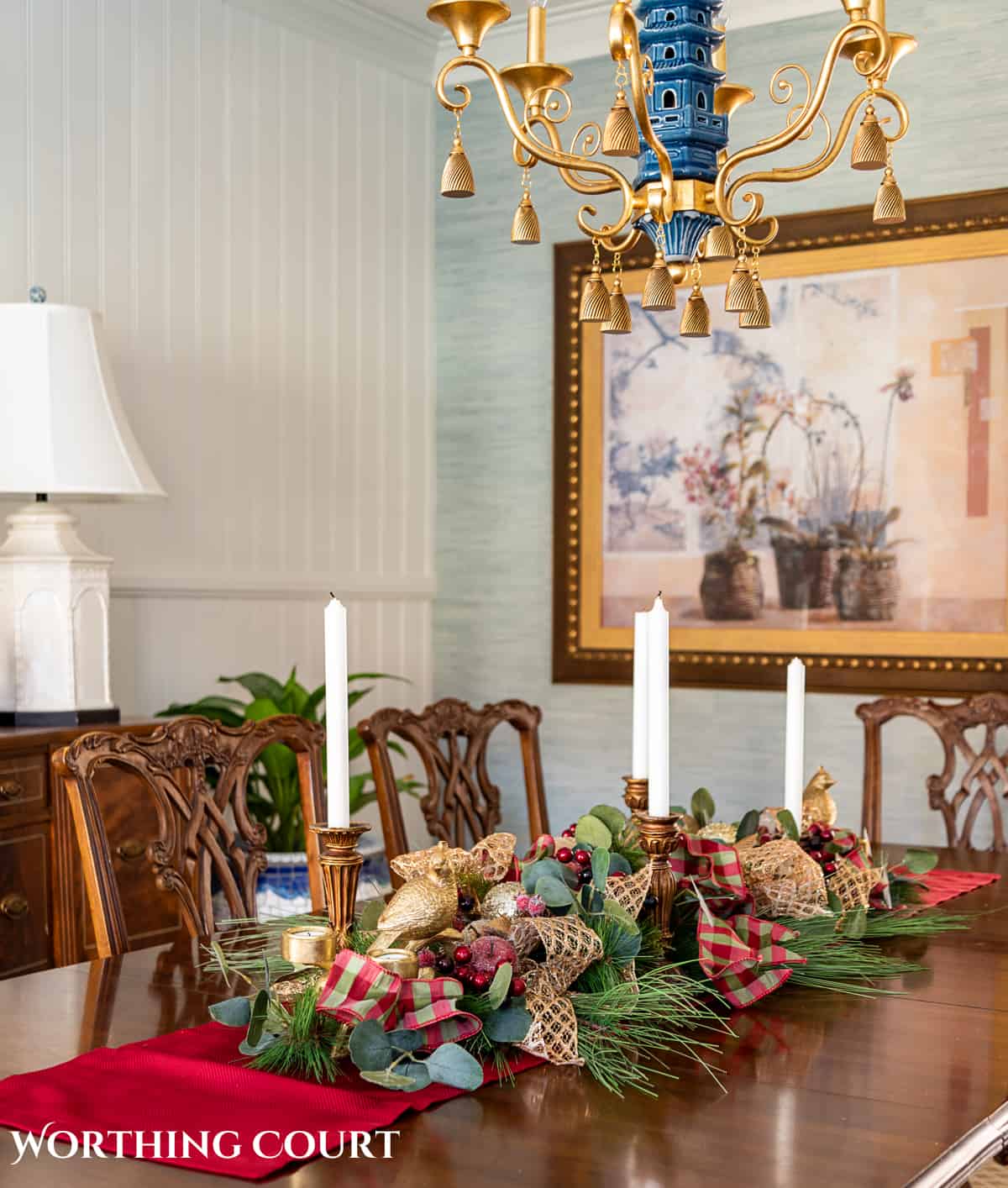 An elegant, but easy Christmas centerpiece made with faux greenery and sugared fruit swags. Includes green, burgundy and gold ribbon, gold candlesticks and white candles.