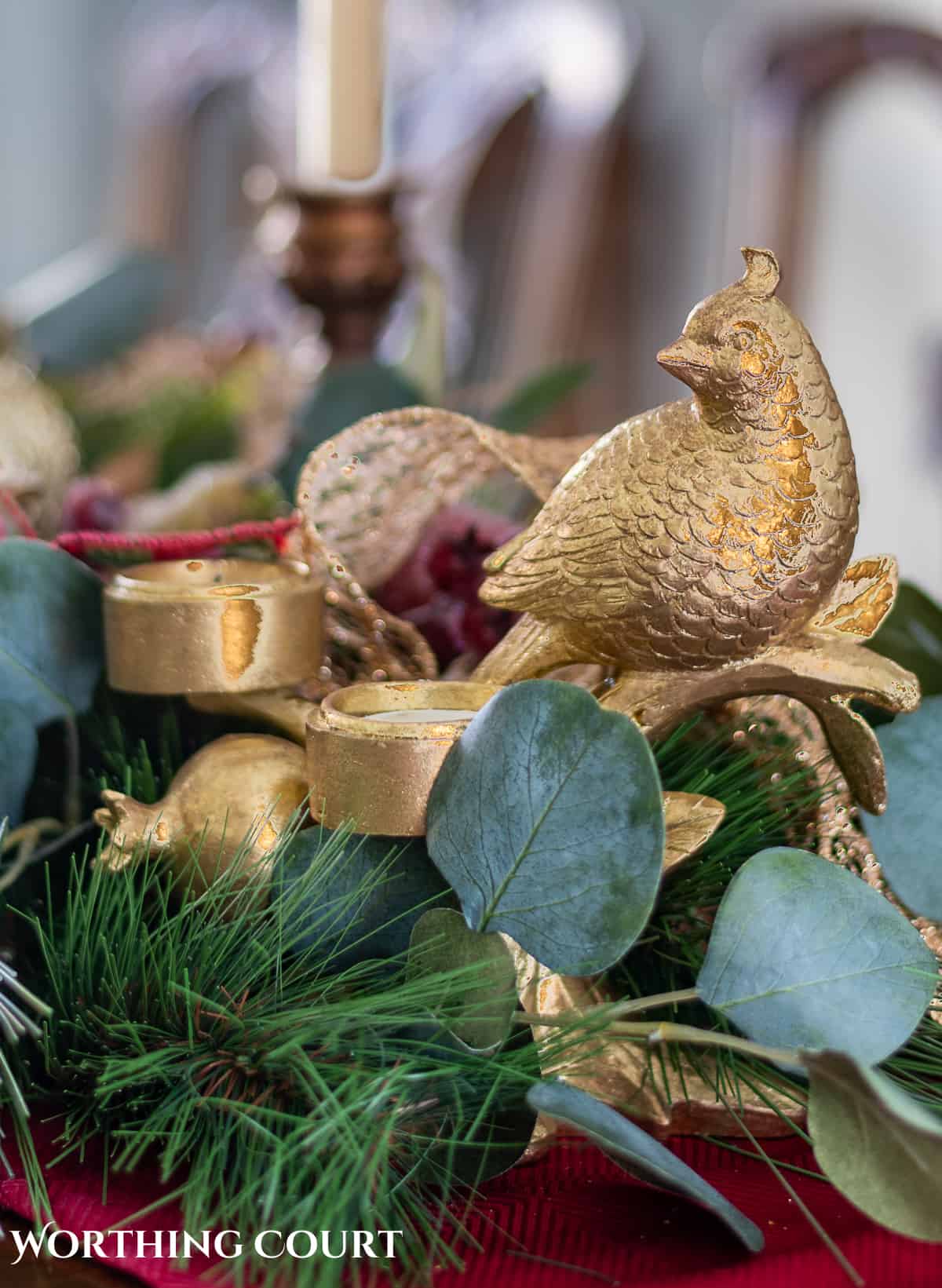 An elegant, but easy Christmas centerpiece made with faux greenery and sugared fruit swags. Includes green, burgundy and gold ribbon, gold candlesticks and white candles.