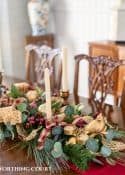 An elegant, but easy Christmas centerpiece made with faux greenery and sugared fruit swags. Includes green, burgundy and gold ribbon, gold candlesticks and white candles.