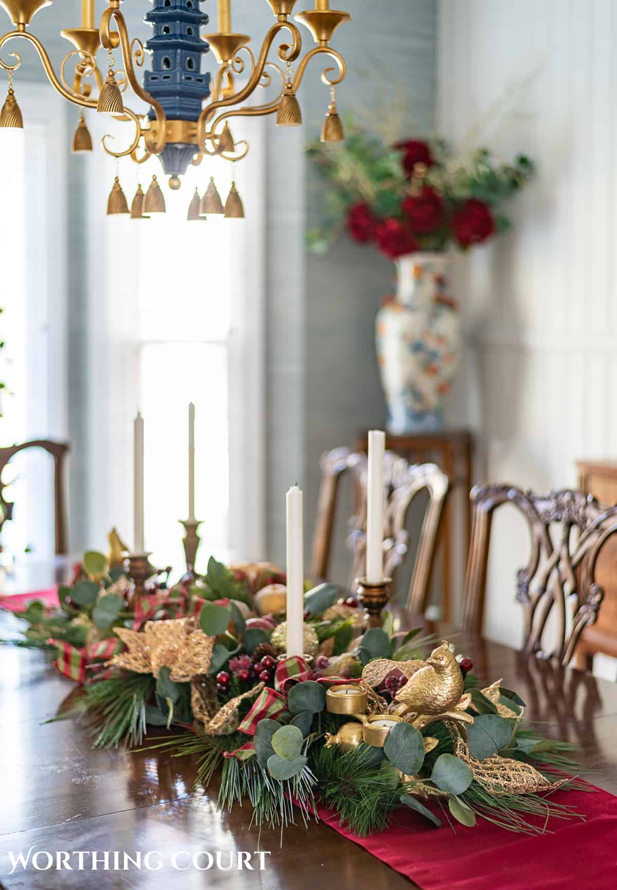 An elegant, but easy Christmas centerpiece made with faux greenery and sugared fruit swags. Includes green, burgundy and gold ribbon, gold candlesticks and white candles.