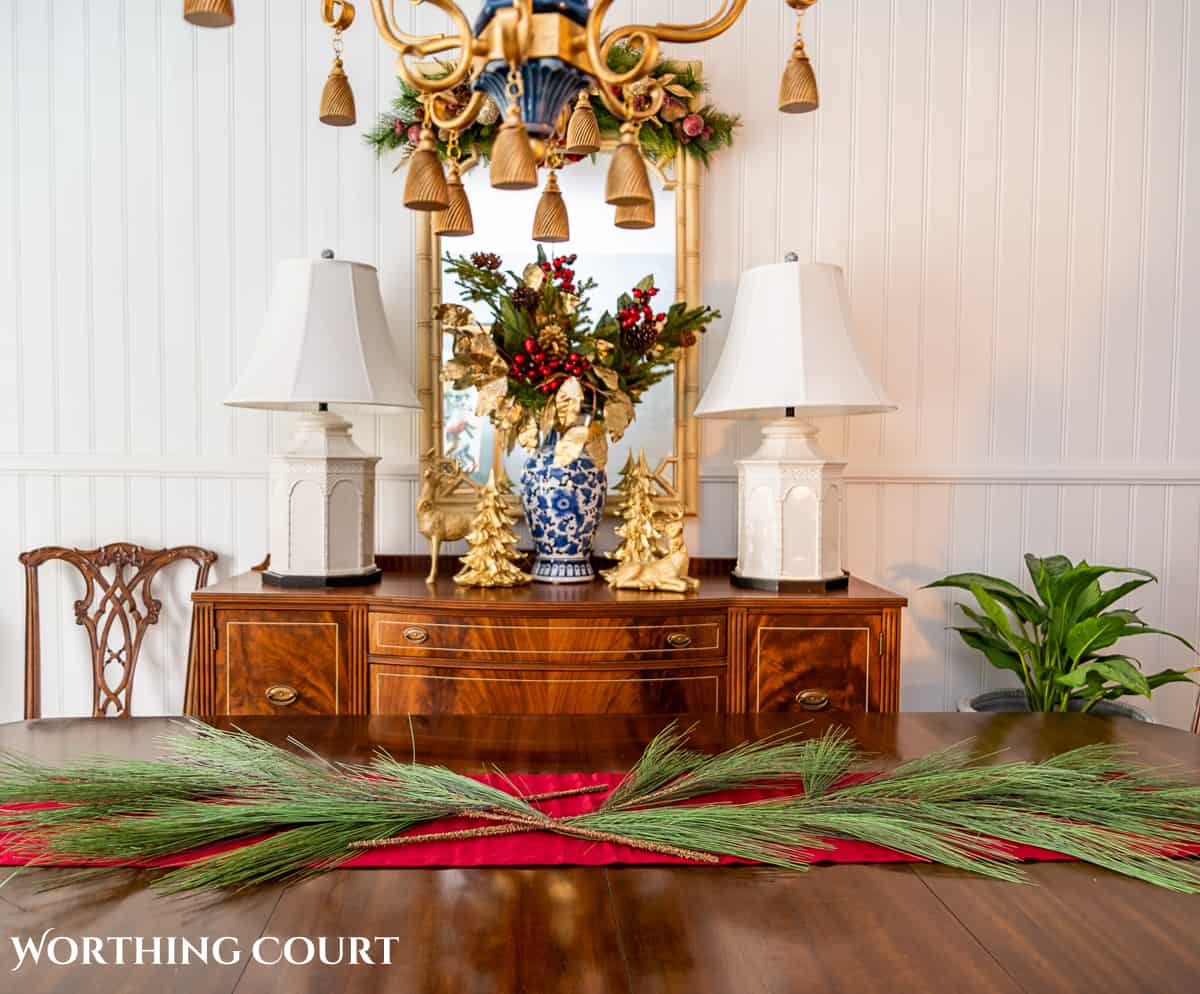 An elegant, but easy Christmas centerpiece made with faux greenery and sugared fruit swags. Includes green, burgundy and gold ribbon, gold candlesticks and white candles.