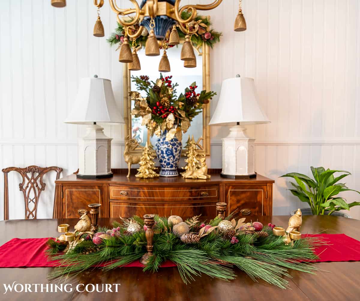 An elegant, but easy Christmas centerpiece made with faux greenery and sugared fruit swags. Includes green, burgundy and gold ribbon, gold candlesticks and white candles.