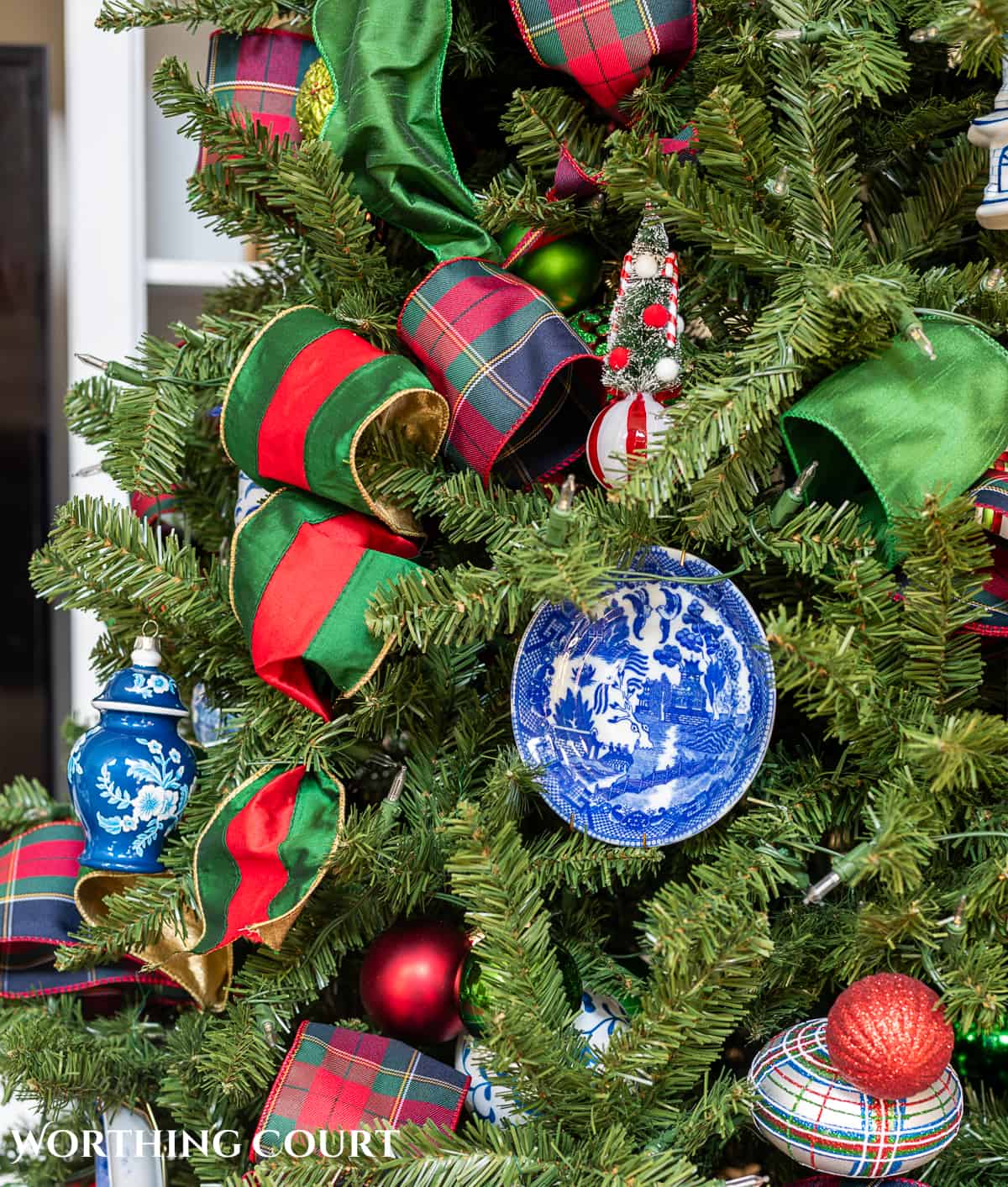 red, green and blue and white traditional decorations on a Christmas tree