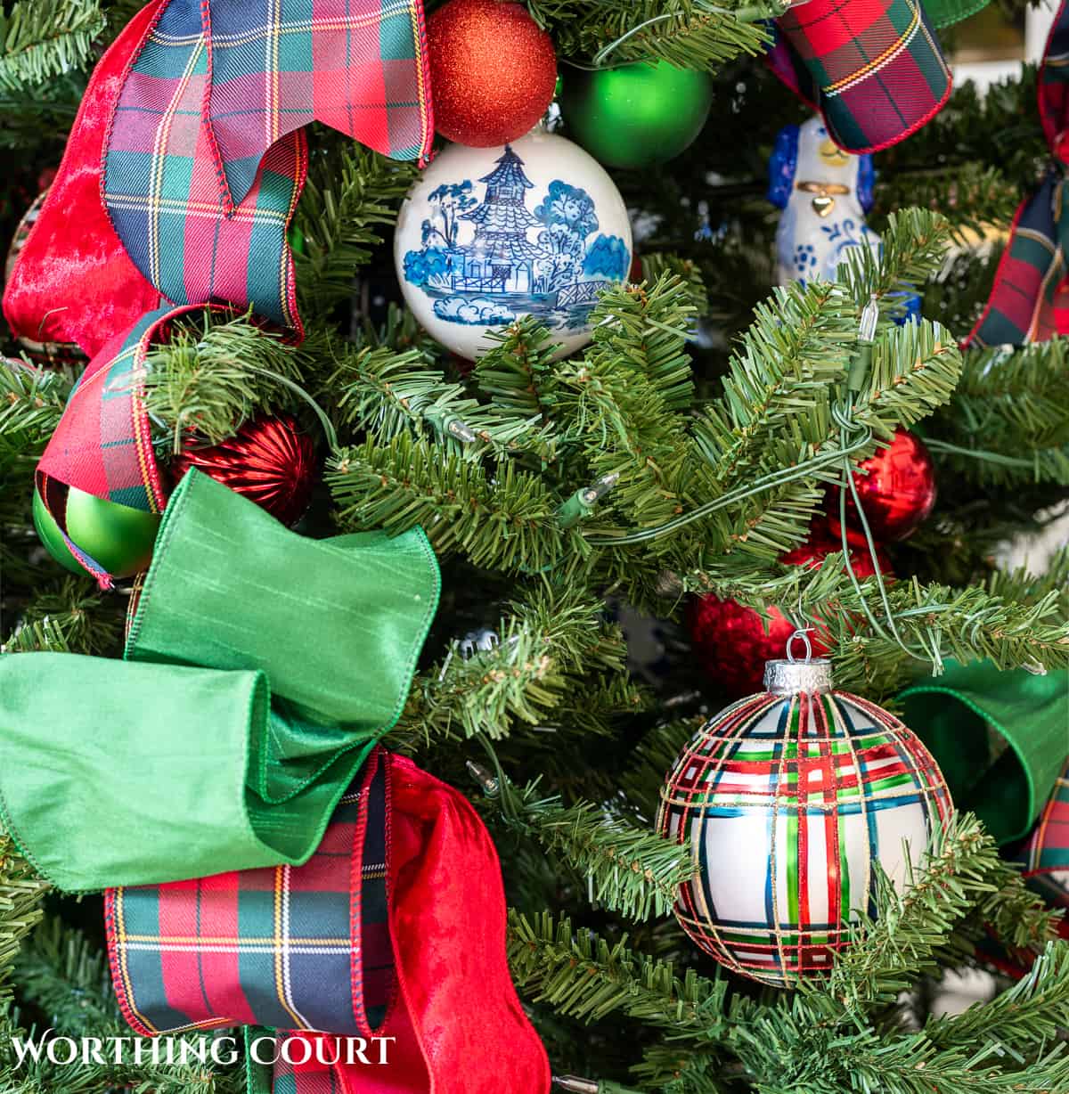 red, green and blue and white traditional decorations on a Christmas tree