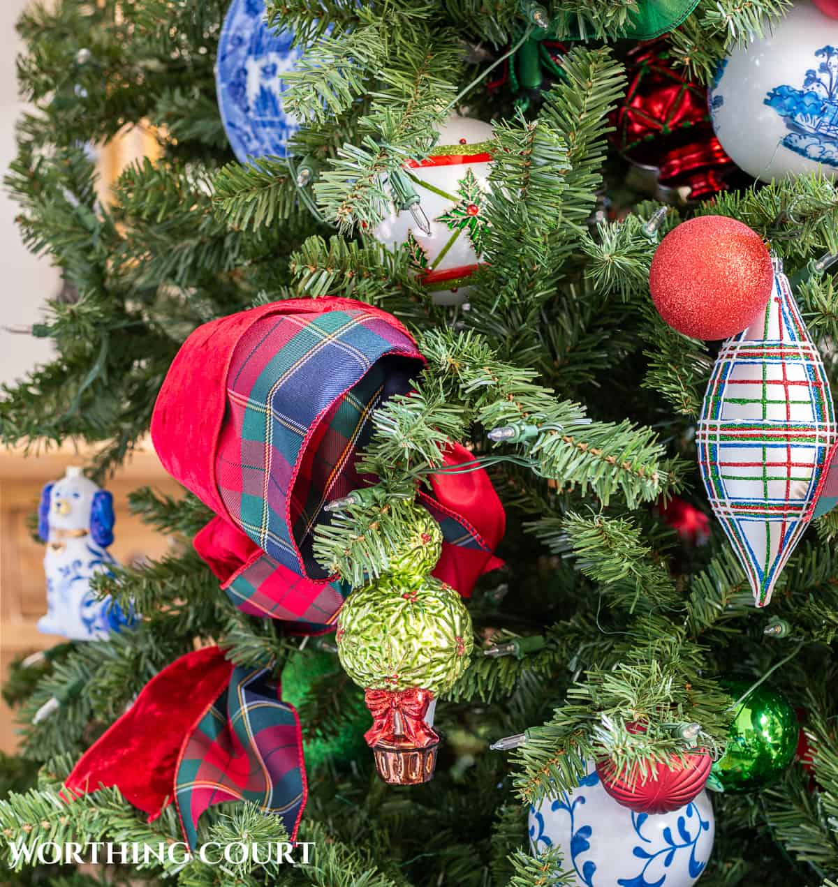 red, green and blue and white traditional decorations on a Christmas tree