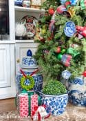 gifts at base of Christmas tree with traditional decorations and presents wrapped in colorful Christmas wrapping paper