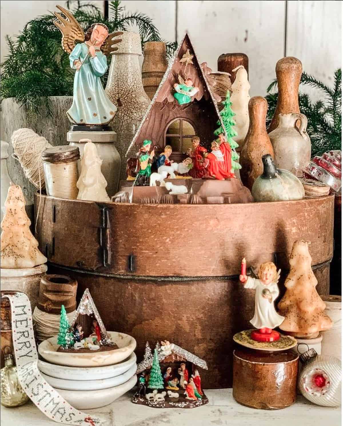 vintage nativity set displayed on and around vintage round wood cheese boxes