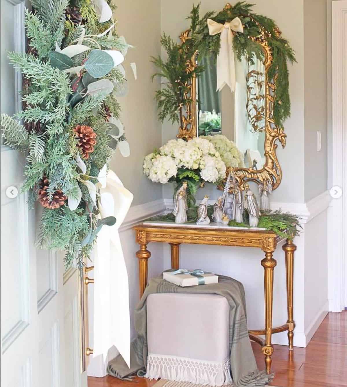 nativity scene displayed on a small table in a foyer