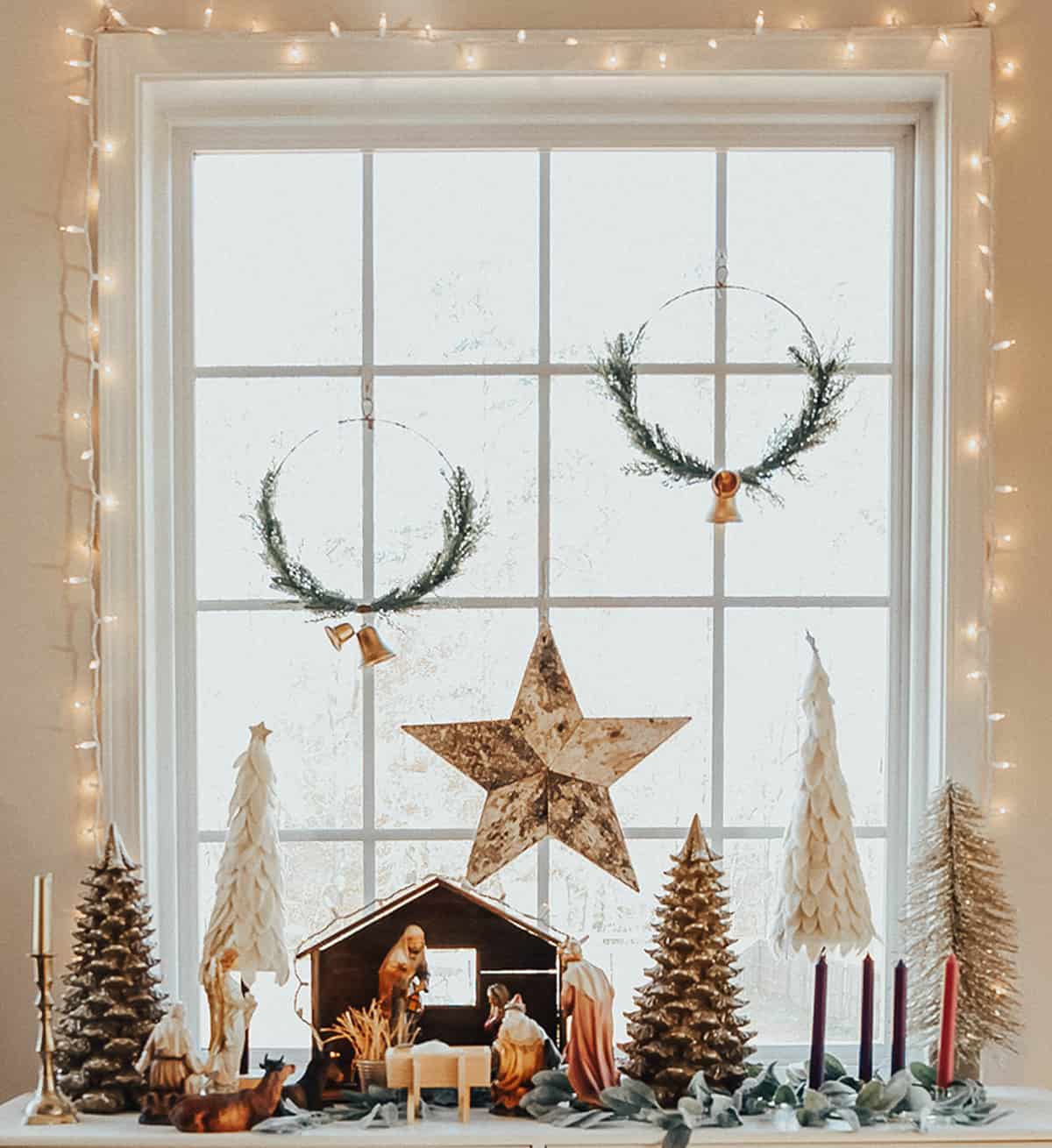 nativity scene display on a table in front of a window