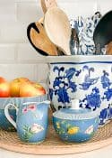 blue and white crock holding various cooking utensils display with blue sugar, creamer and bowl