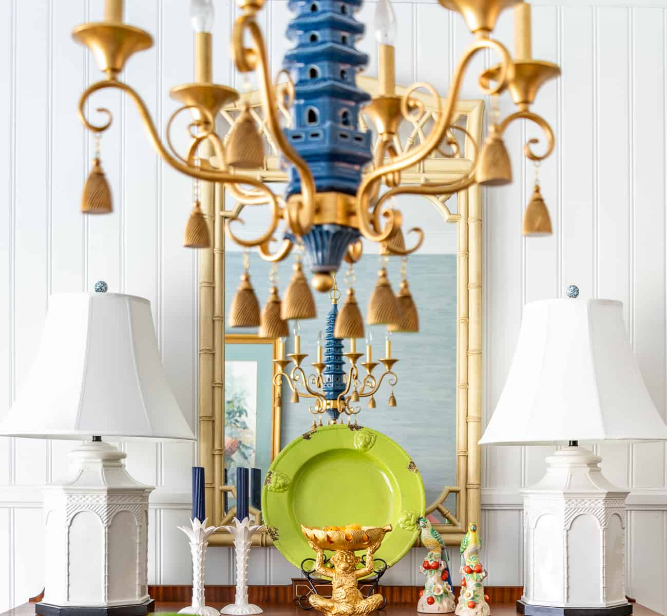 blue and gold pagoda style chandelier and a vignette on a dining room sideboard