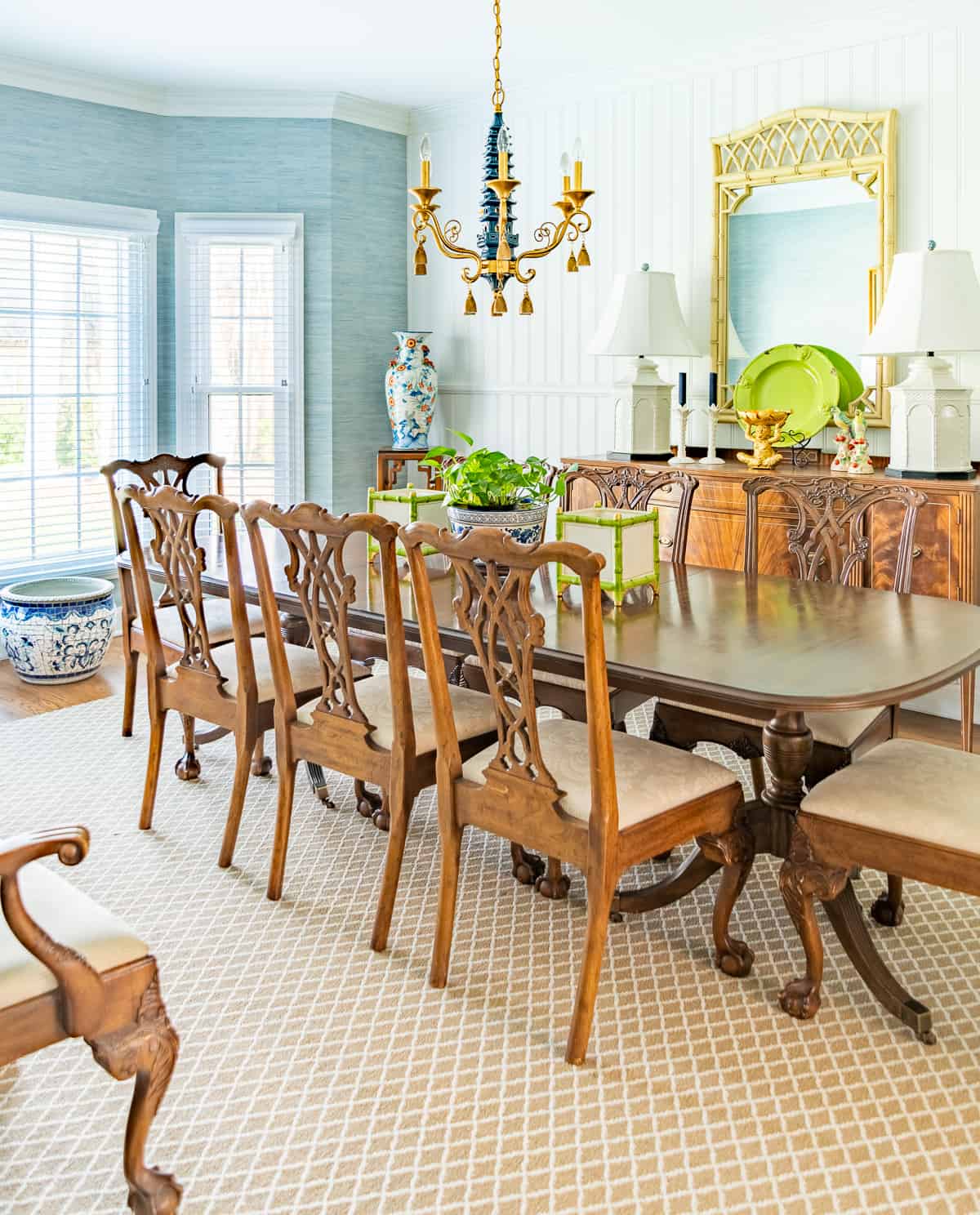 stylish dining room with new trad decor including chippendale style table and chairs, neutral rug, pagoda chandelier and updated accessories.