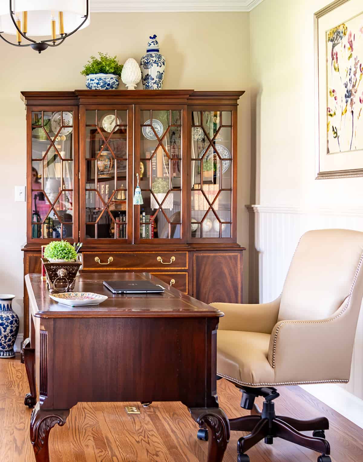 China cabinet in a home office filled with office type accessories - very on trend for 2024