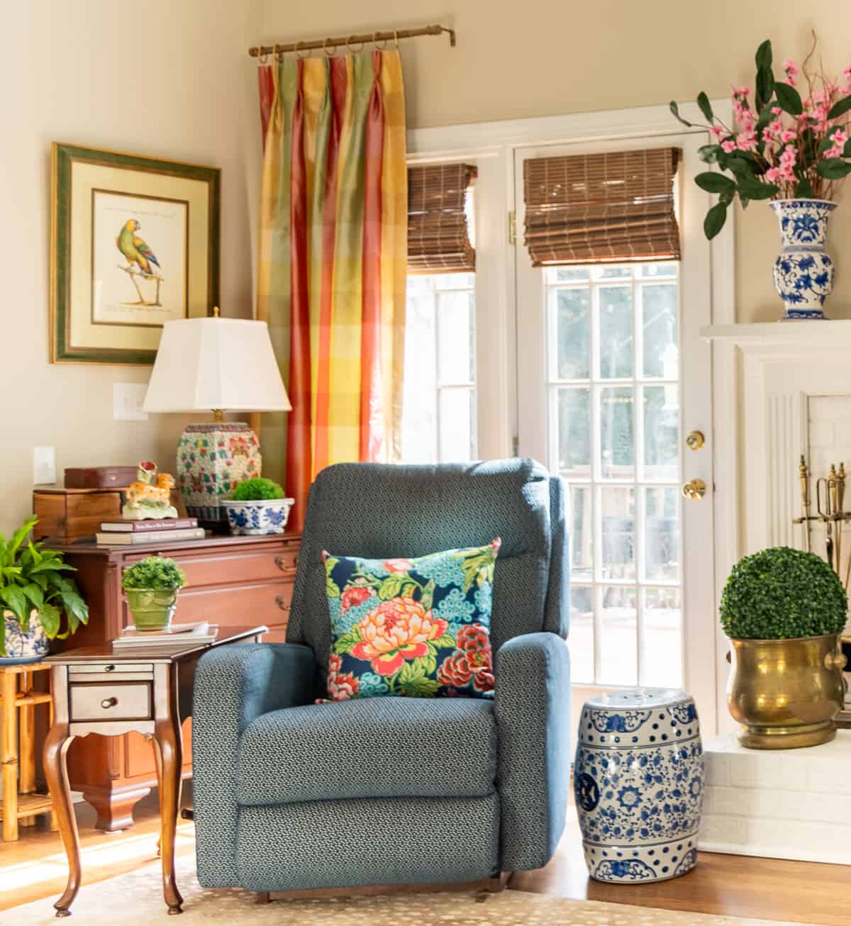 living room decorated in new traditional style with blue recliners, wood tables, colorful accessories and a faux antelope area rug