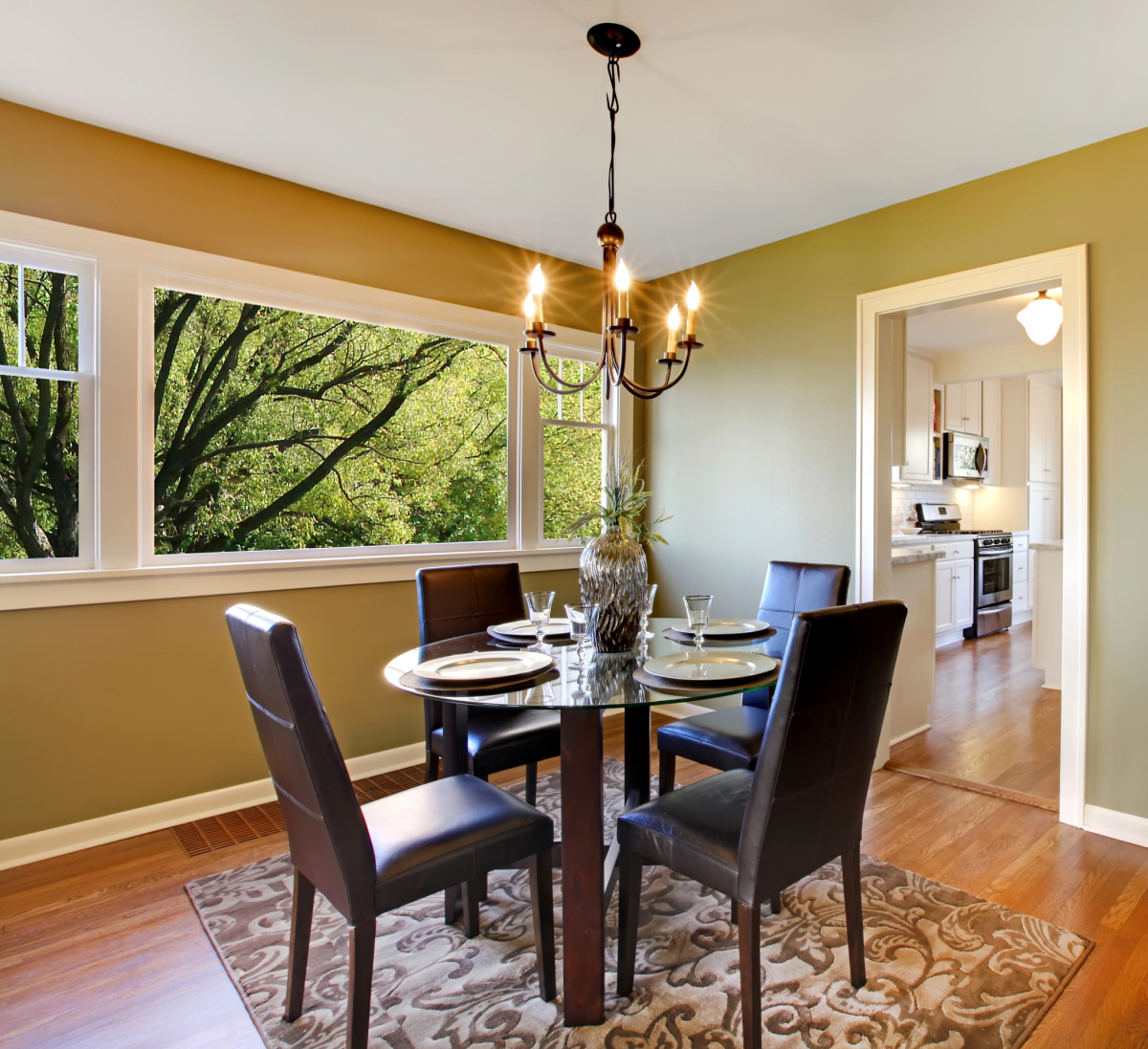 a dining area with an area rug that is too small