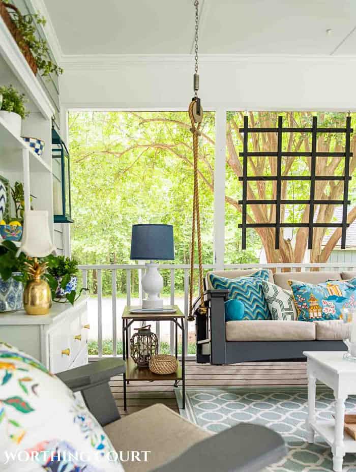 Partial view of screen porch swing and decorations