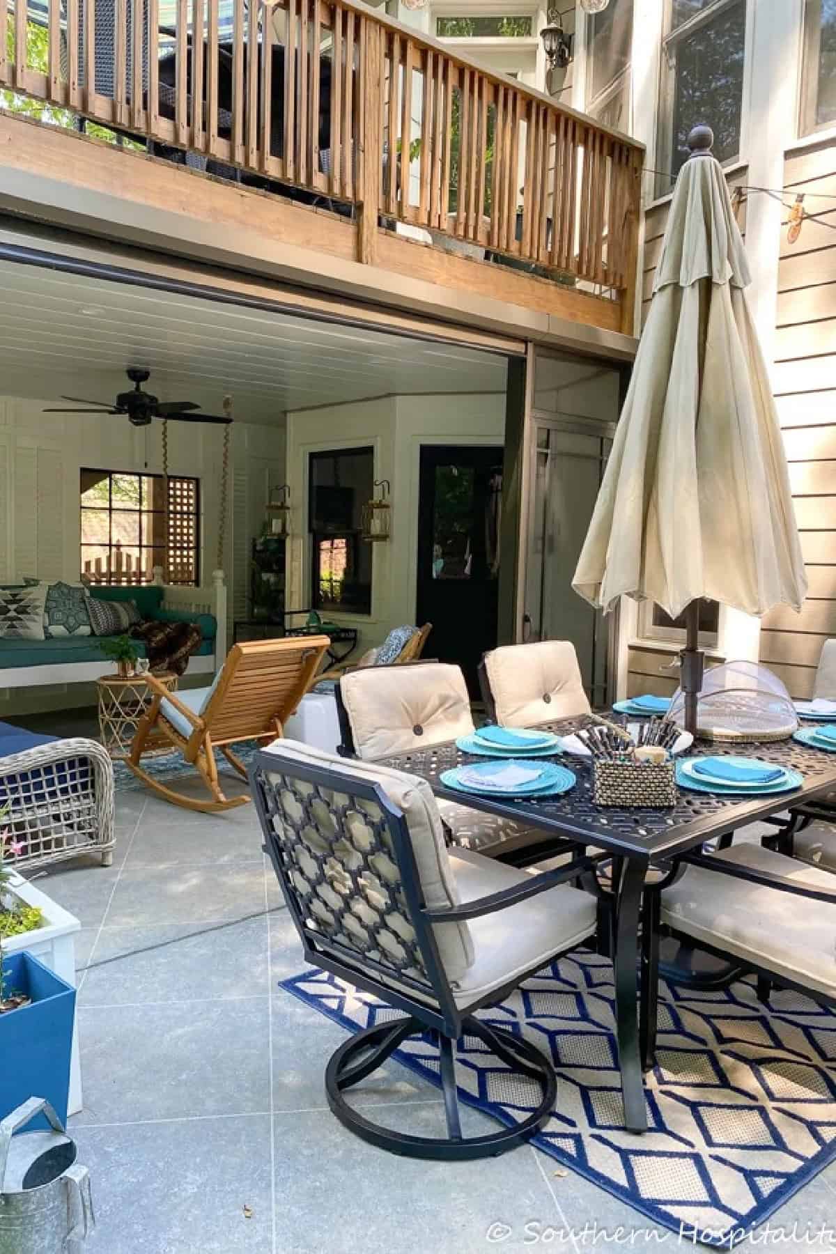 porch and patio under a wooden deck with blue and teal decor