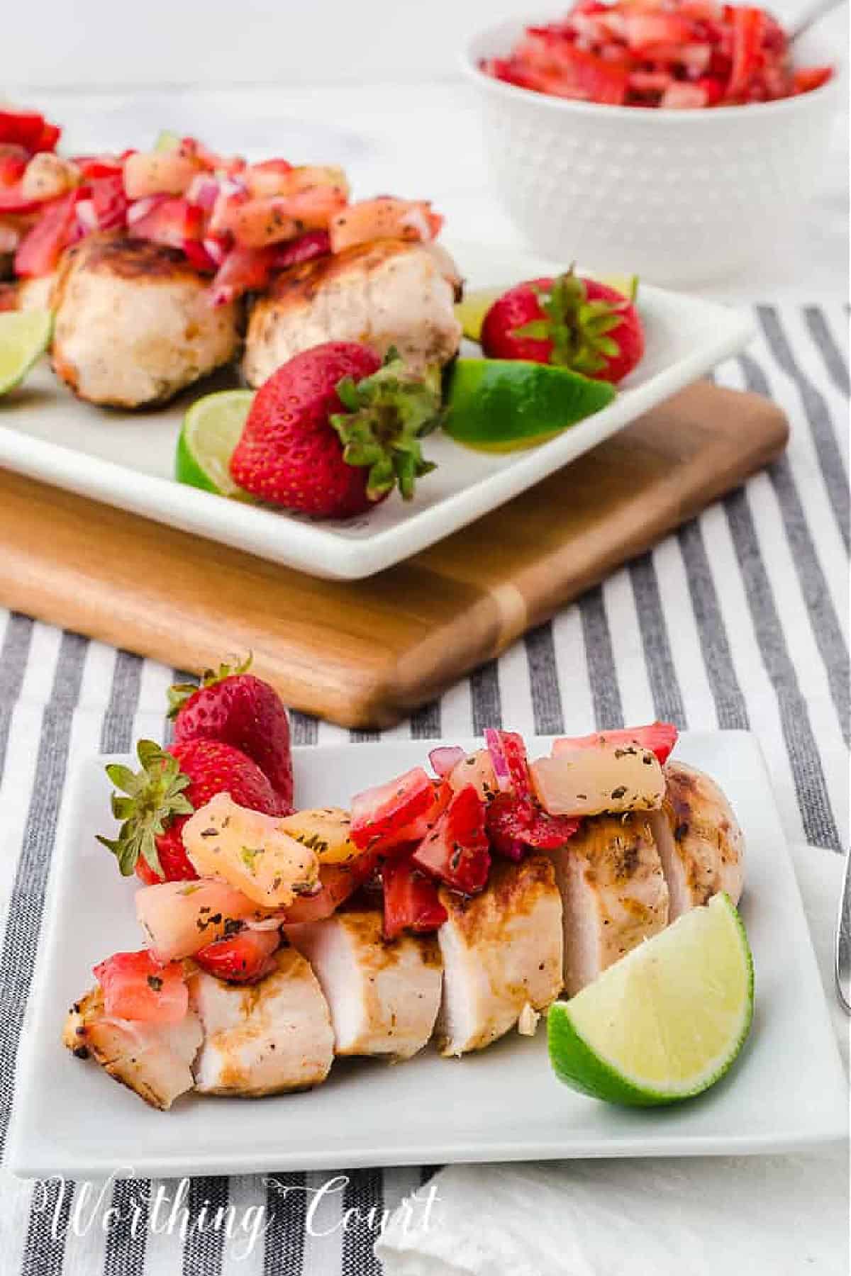 Sliced grilled chick breast topped with strawberry and pineapple salsa