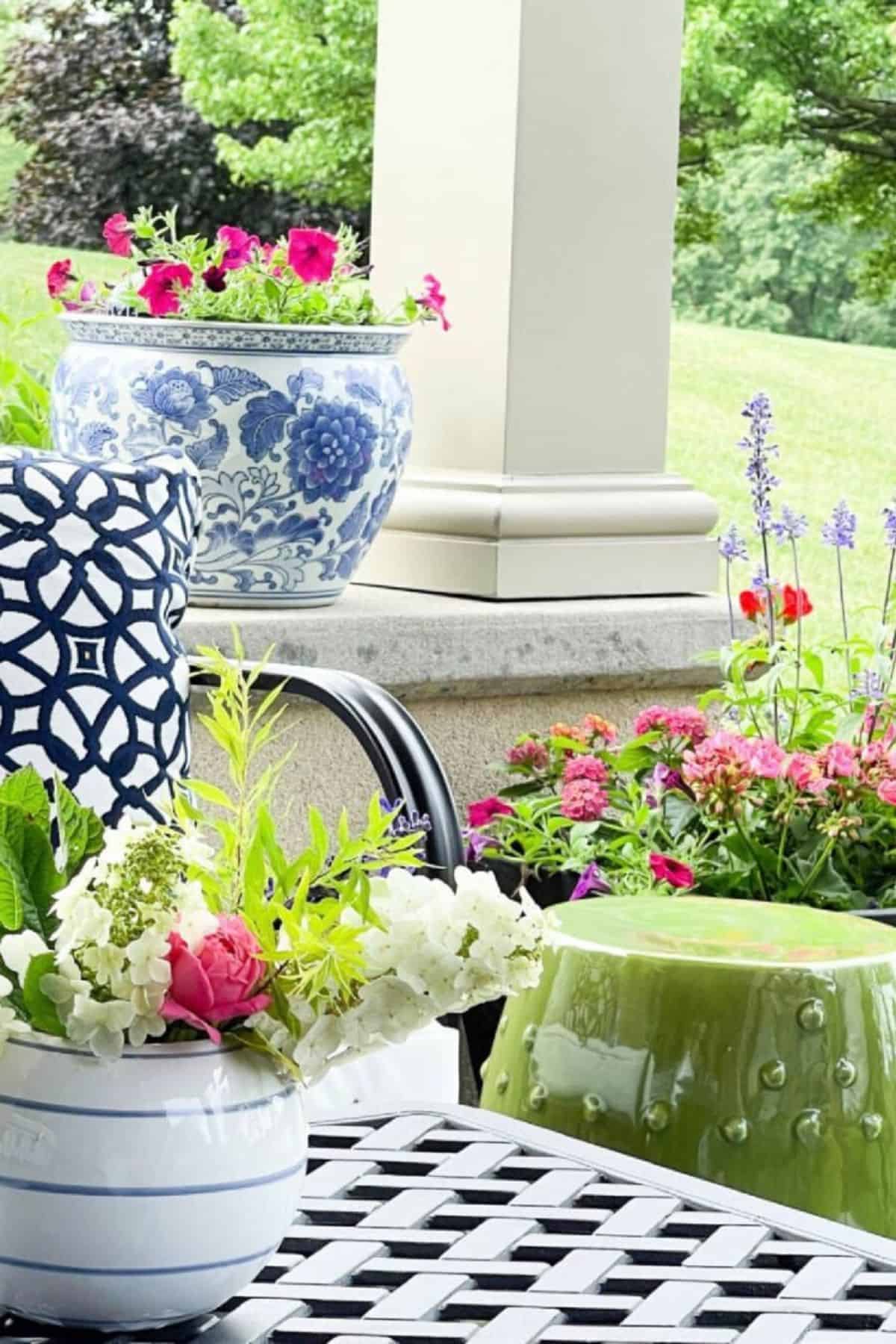 pink flowers planted in containers ona patio for summer