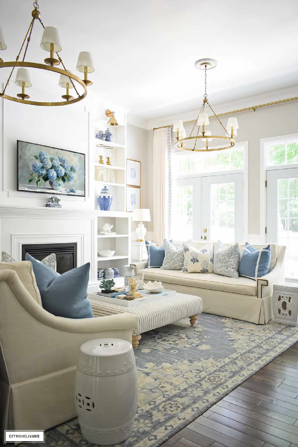 serene living room with white walls and sofas with blue and white summer decor