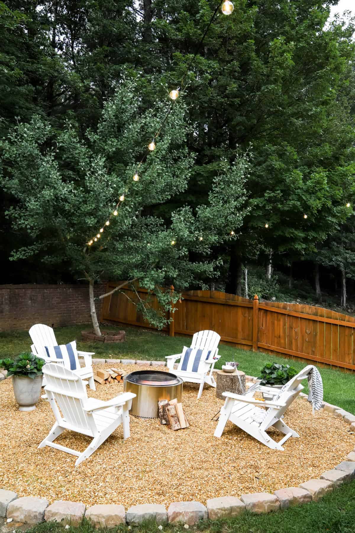outdoor firepit surrounded with white chairs