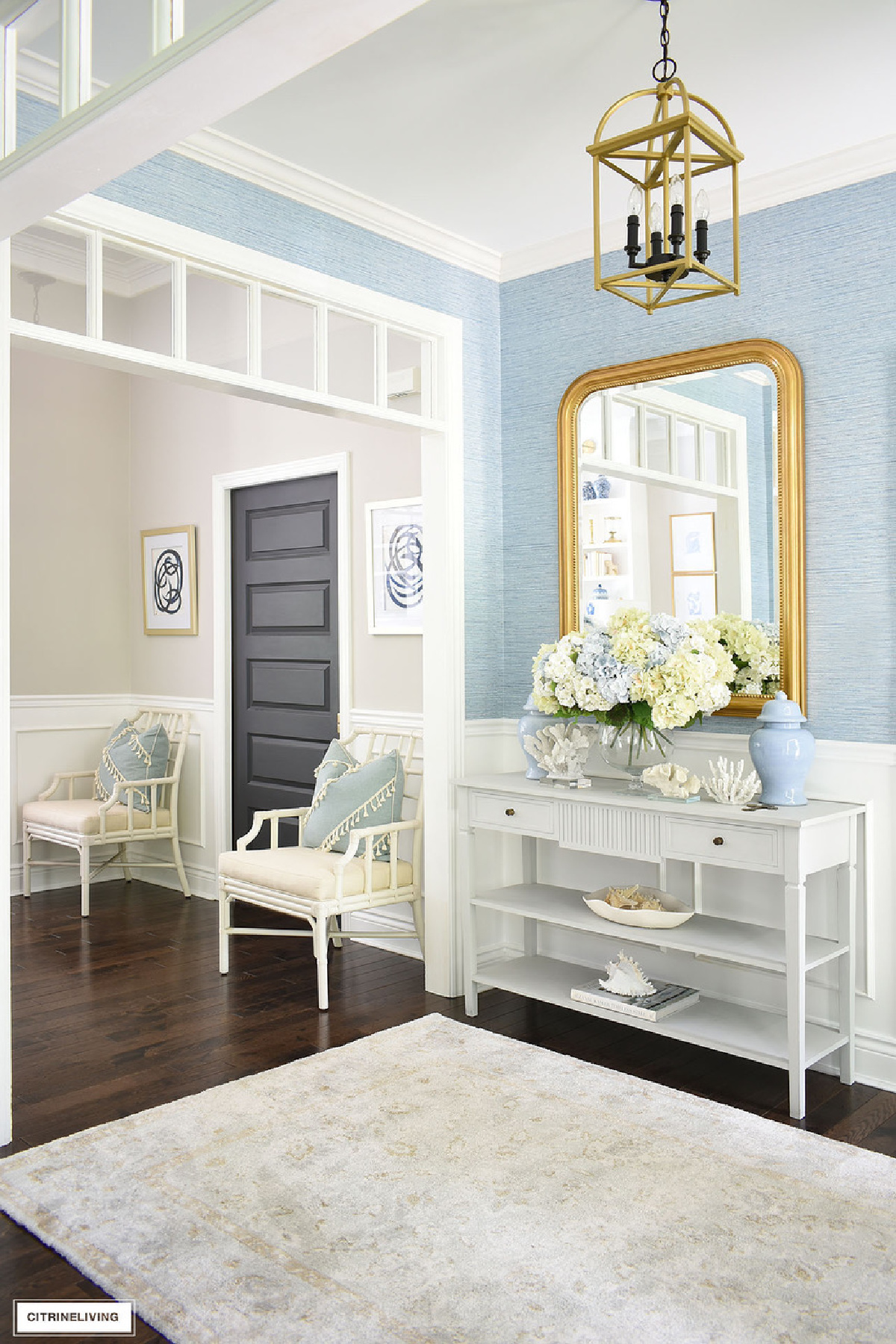 foyer with white furniture, blue walls and blue and white accessories