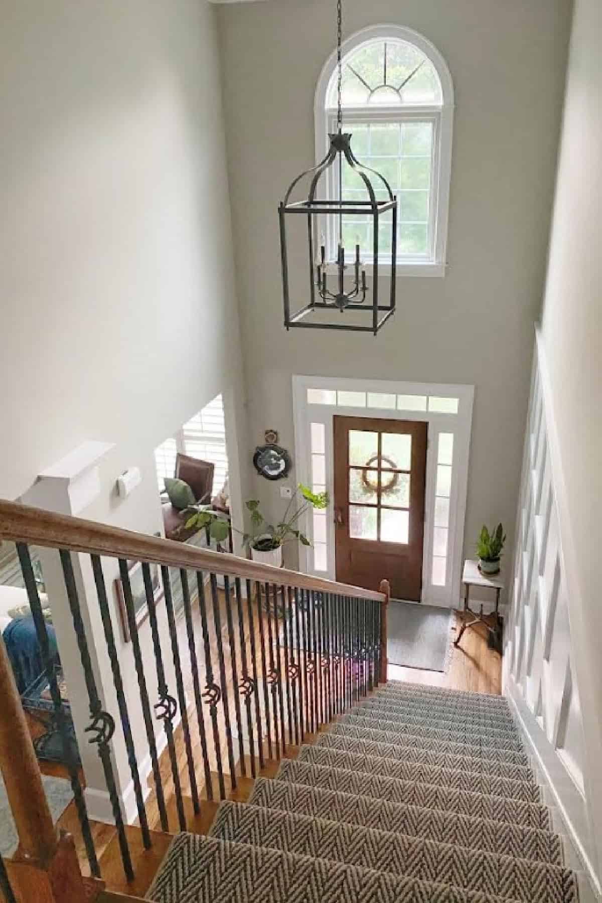 looking down a stairway into a foyer