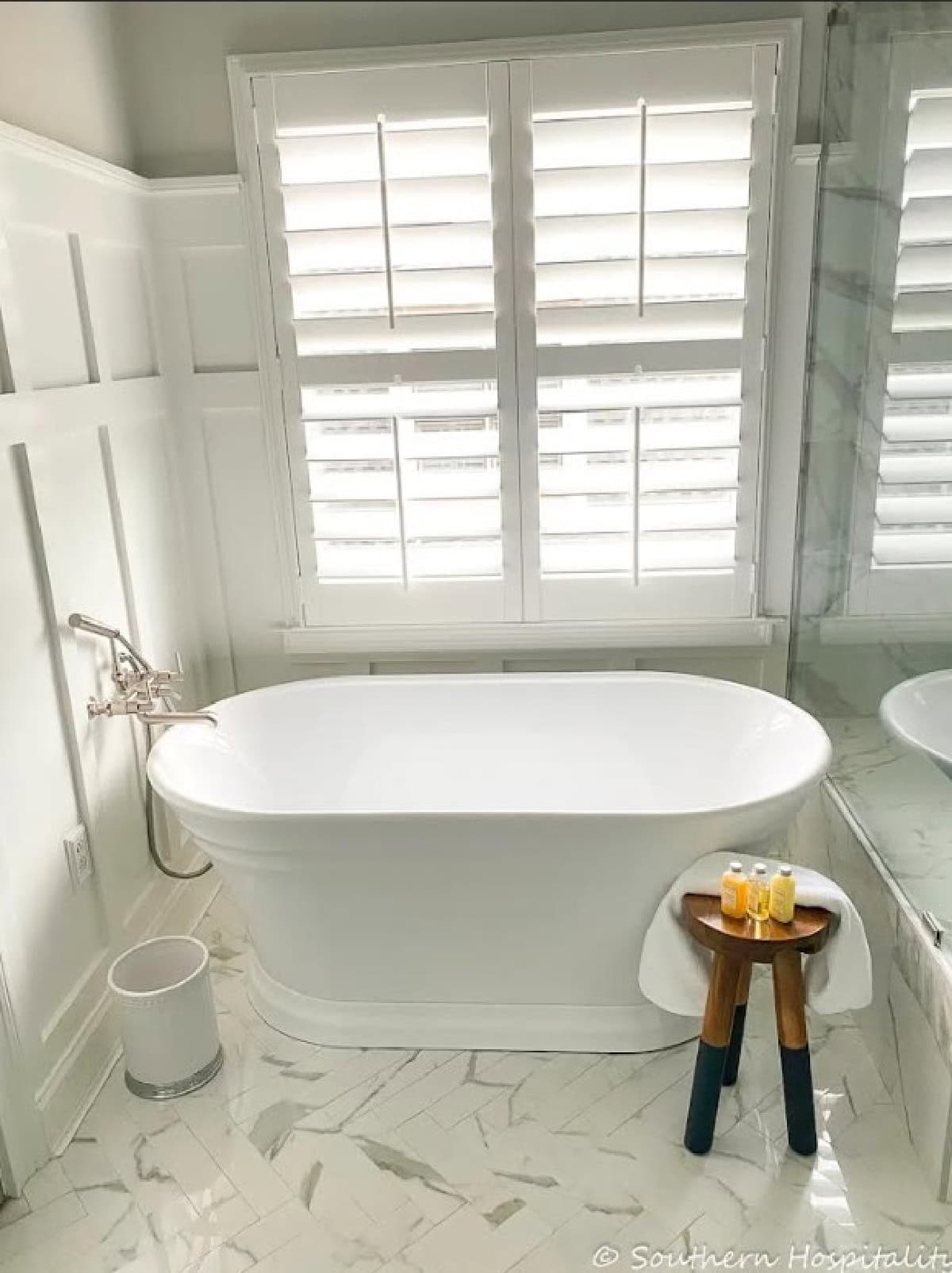 oval free standing bathtub in a remodeled bathroom