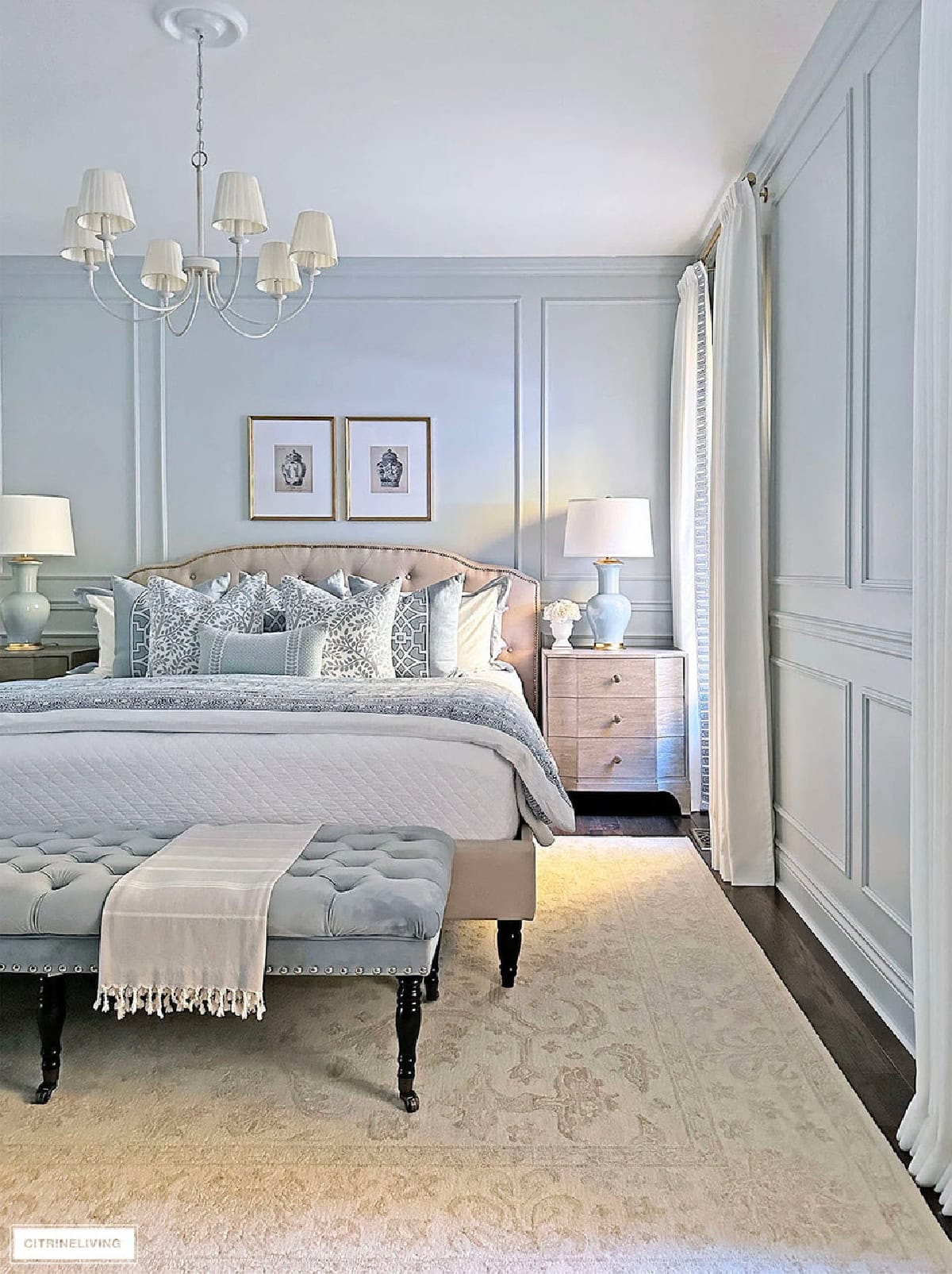 Elegant bedroom with pastel accents, cozy bedding, and classic decor for a relaxing home ambiance.