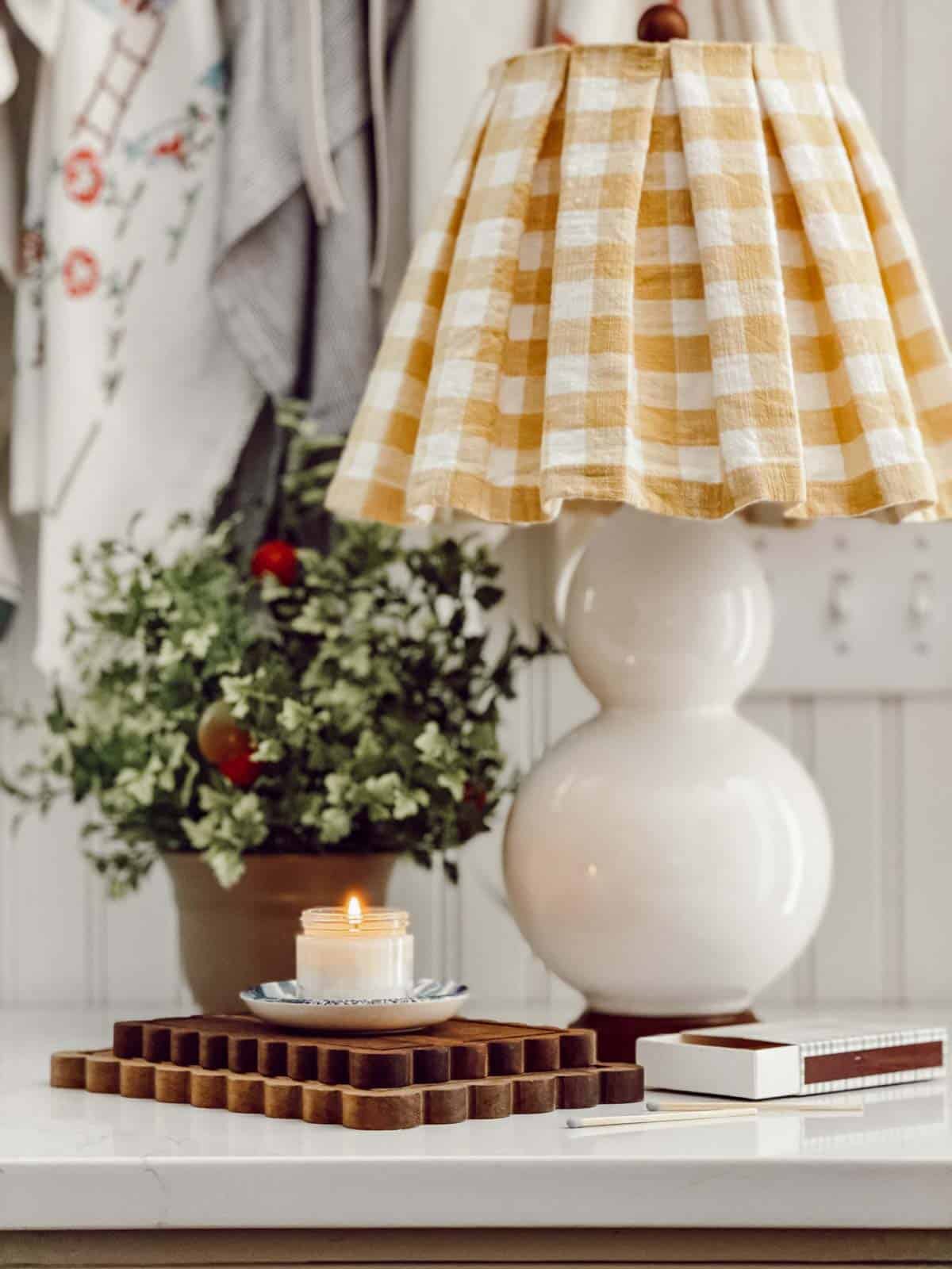 white lamp with a pleated lampshade made with yellow and white checked fabric