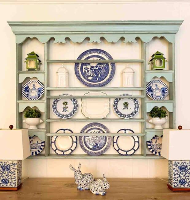 blue plate rack filled with blue, white and green chinoiserie plates and accents