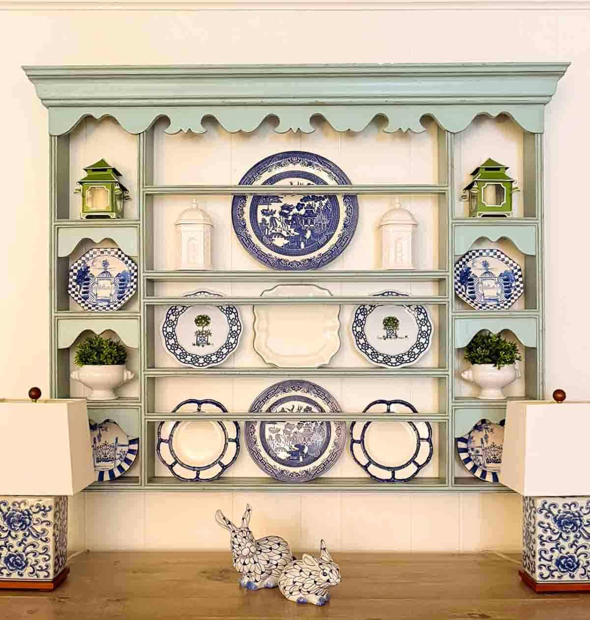 blue plate rack filled with blue, white and green chinoiserie plates and accents