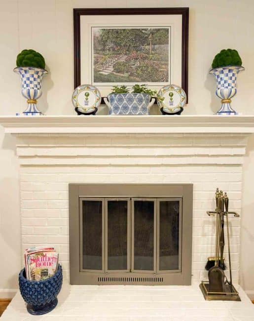 white brick fireplace with blue and white accessories