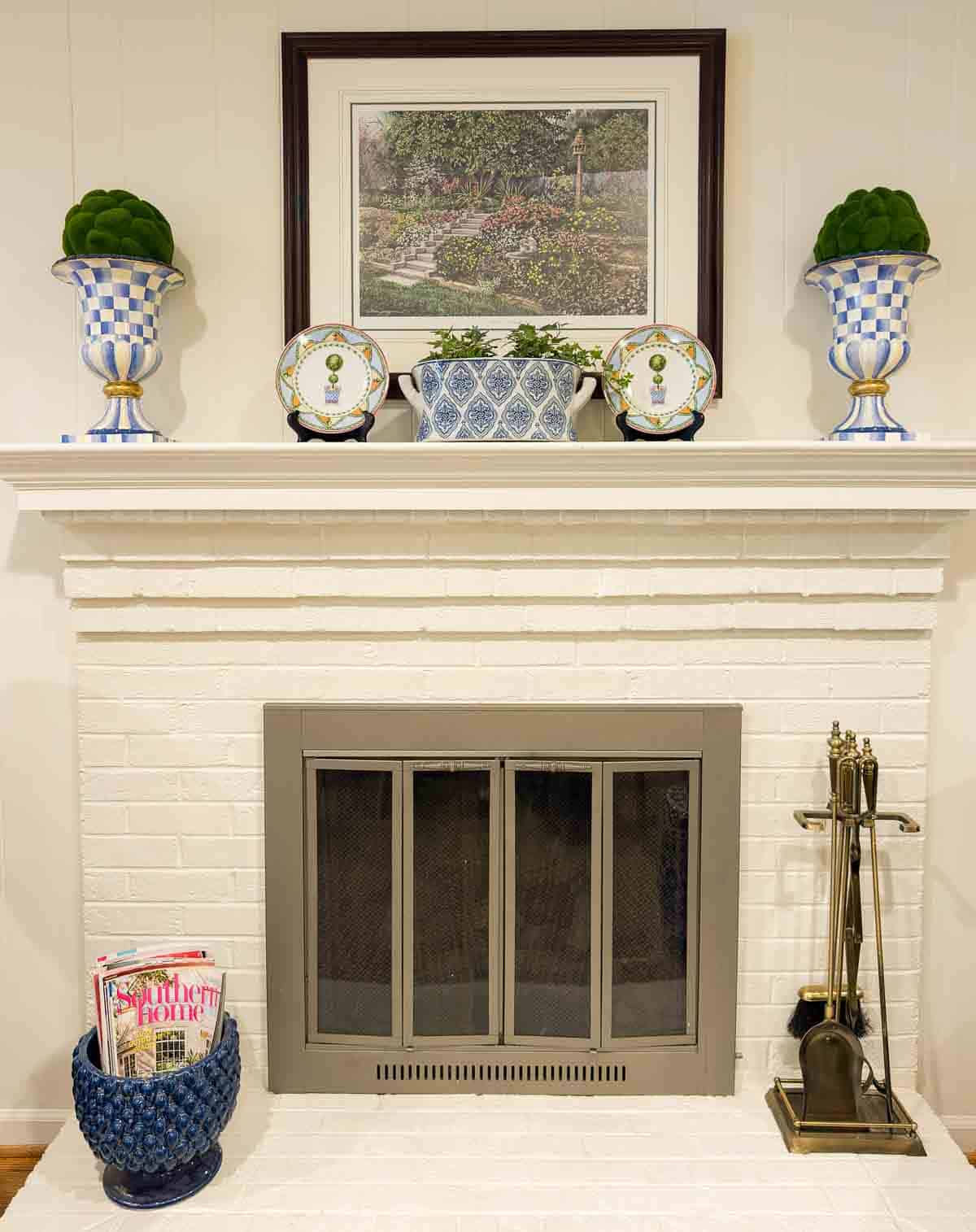 white brick fireplace with blue and white accessories
