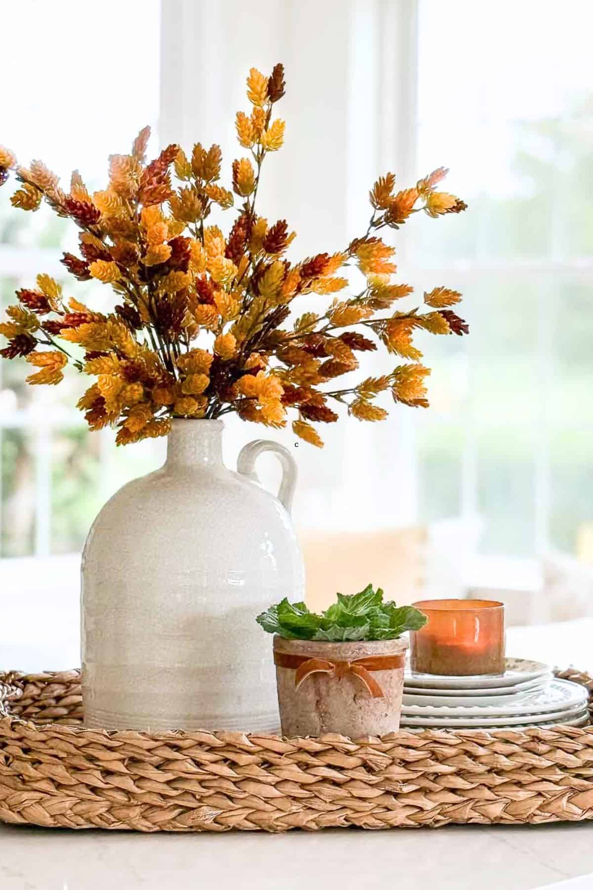 golden faux hops stems in a white pitcher