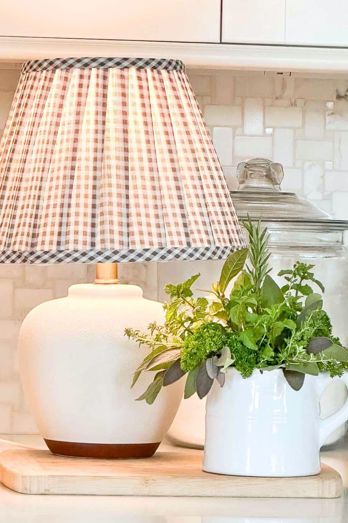 small white lamp with a brown and white gingham check shade