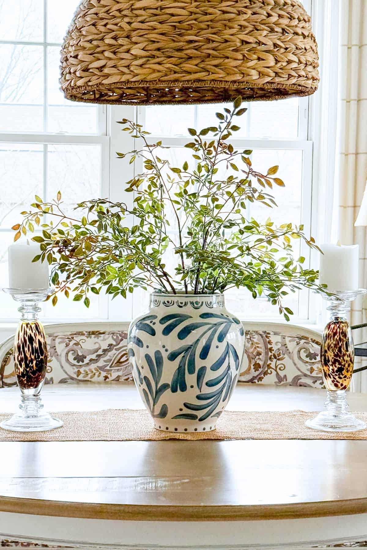 blue and white vase filled with spring floral and greenery stems