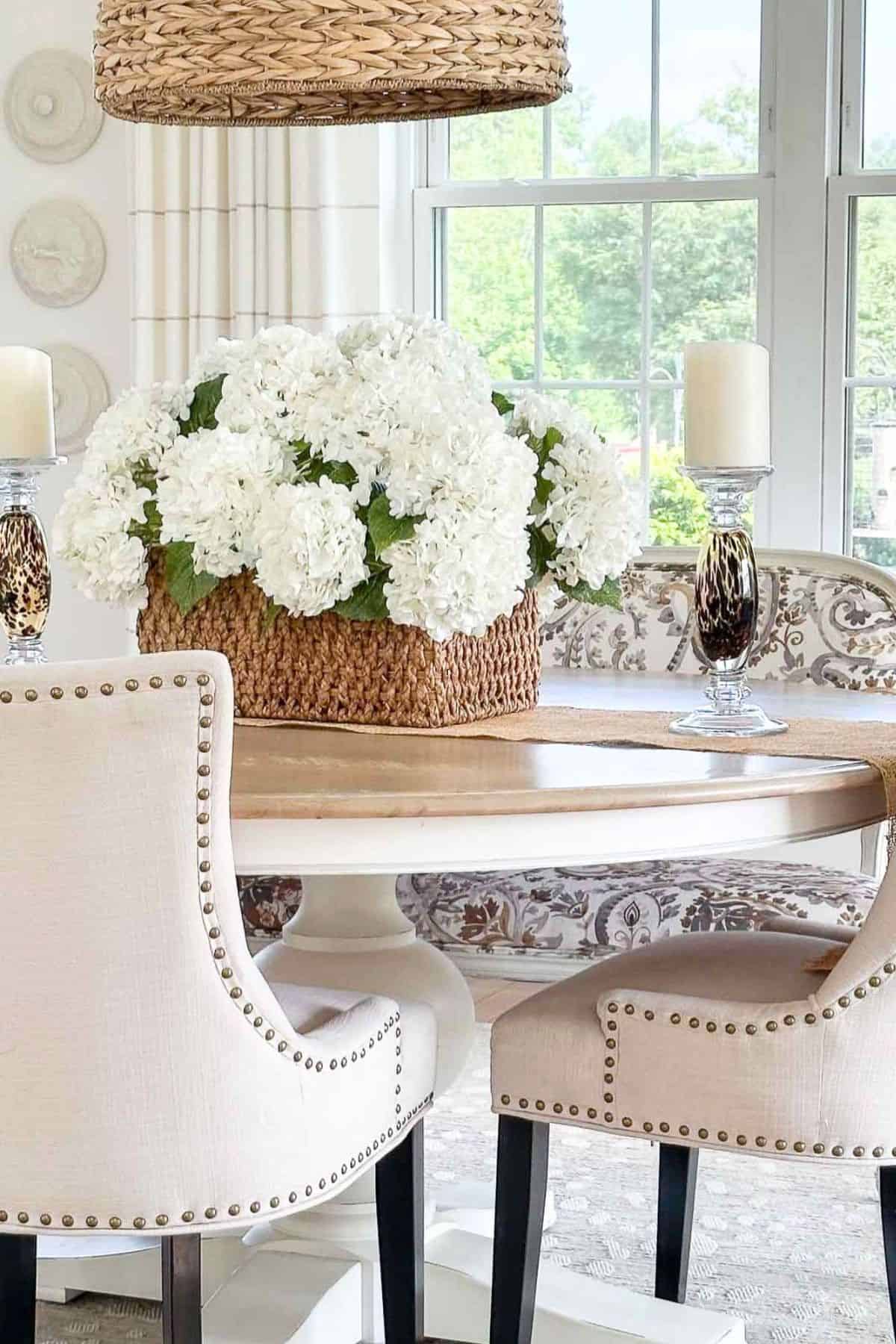 basket of white hydrangeas on a round dining table