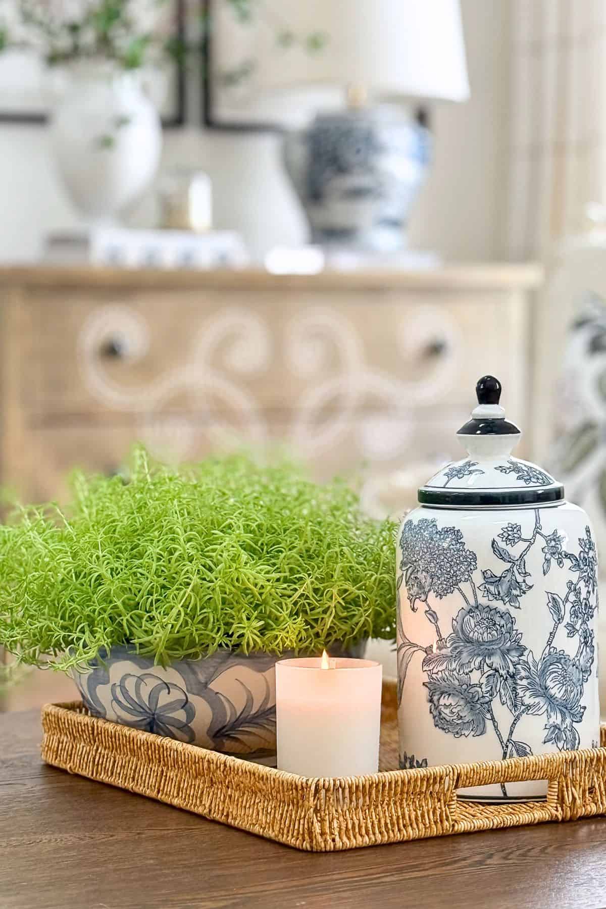blue and white ceramic jar in a vignette on a wicker tray
