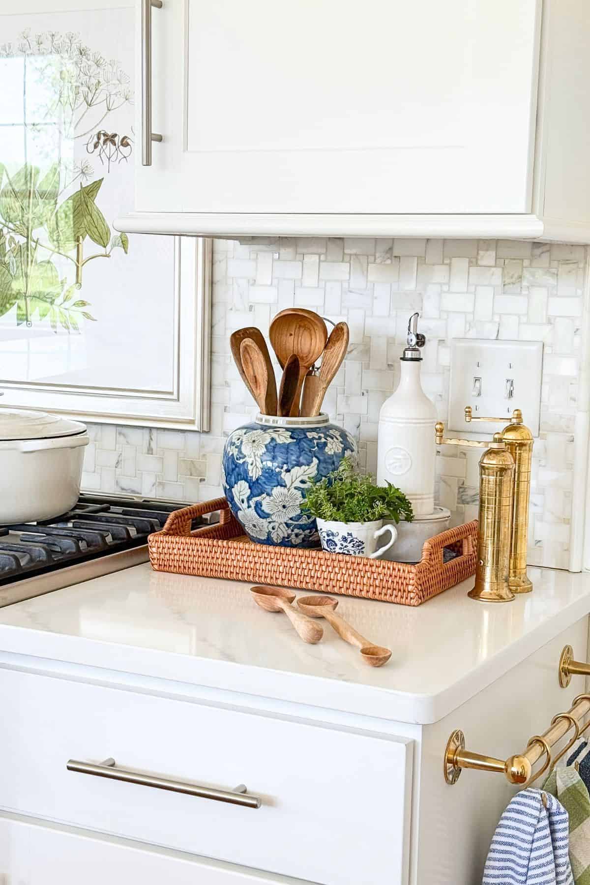 kitchen vignette in a wicker tray on a white counter