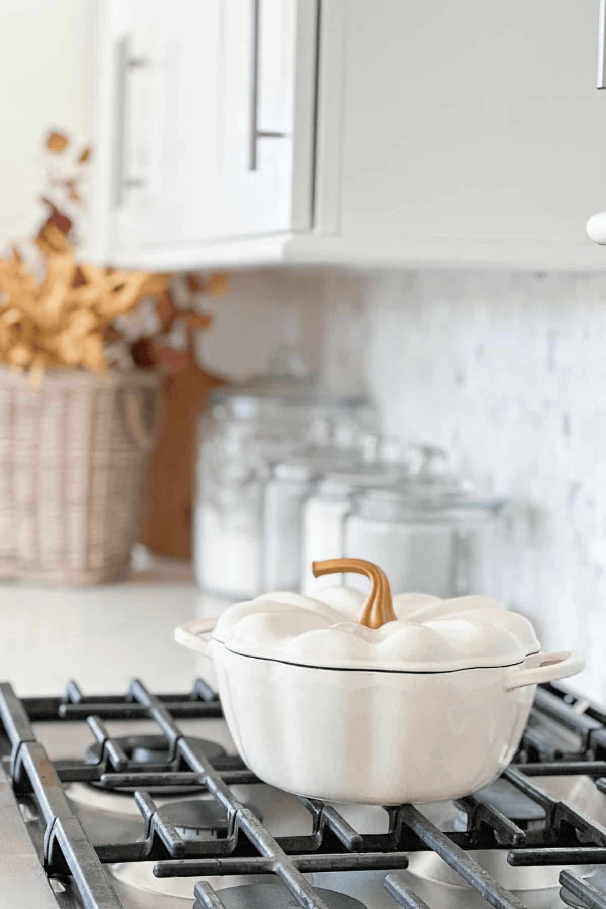 white pumpkin shaped cooking pot on top of a gas range